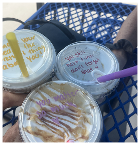 Iced coffee drinks with uplifting handwritten messages at a local Port St. Lucie café