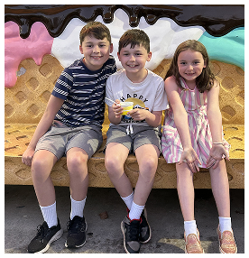 Smiling children sitting on ice cream-themed bench in Port St. Lucie, Florida