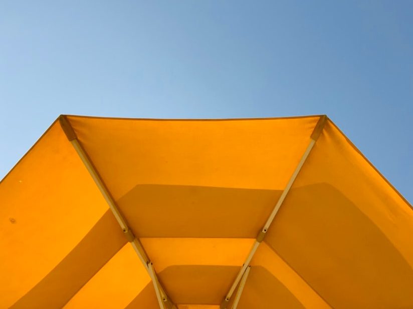 Bright yellow patio umbrella at PGA Verano outdoor living area in Port St. Lucie, Florida